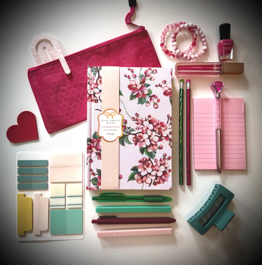 Bloom & Blush Box – Back to School Gift Set flatlay with floral journal, berry pencil pouch, pink stationery, bracelets, lip oil, and nail polish